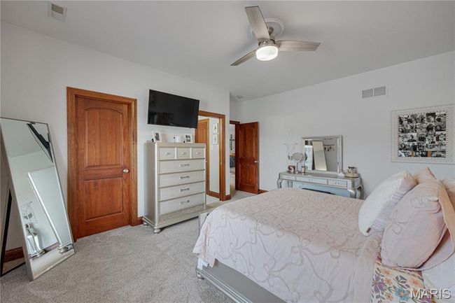 Bedroom with light carpet and a ceiling fan | Image 32