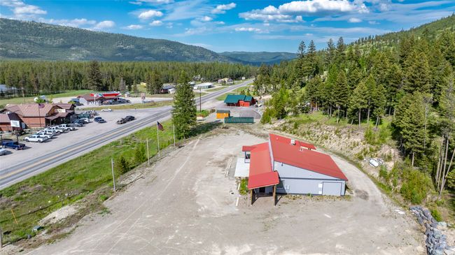Aerial view of a mountain backdrop and a heavily wooded area | Image 96