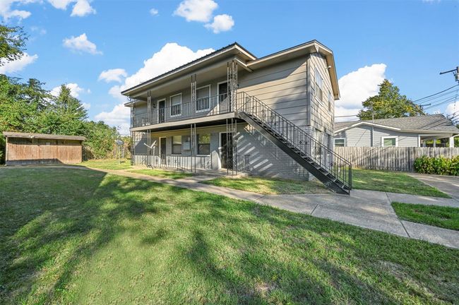Back of house with covered porch, stairs, and a balcony | Image 16