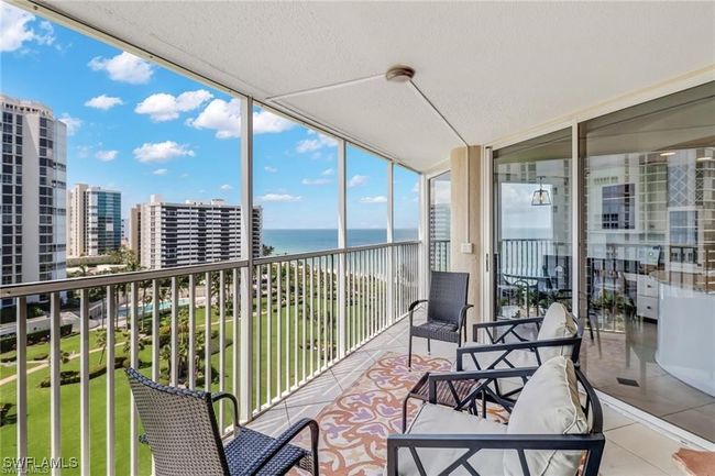 Sunroom featuring a water view | Image 29