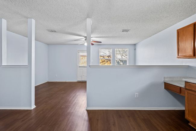 Kitchen featuring ceiling fan, dark wood-type flooring, and a textured ceiling | Image 9