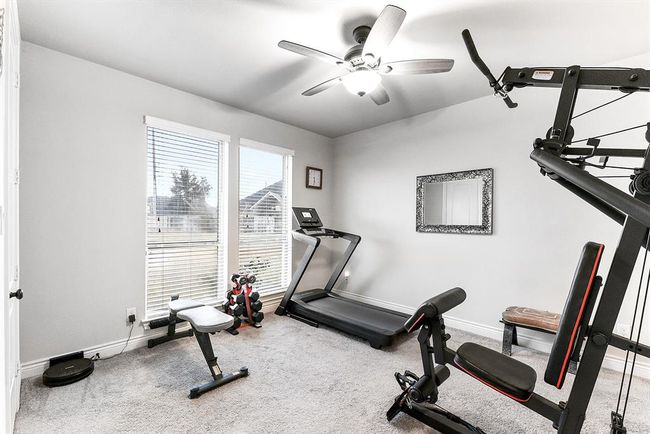 The second guest en suite offers an attached bathroom and beautiful backyard views. Currently, the owner is using this room as a home gym, but it can easily be adapted to suit your needs. | Image 42