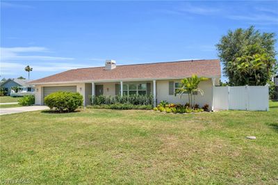 Single story home with a garage and a front lawn | Image 3