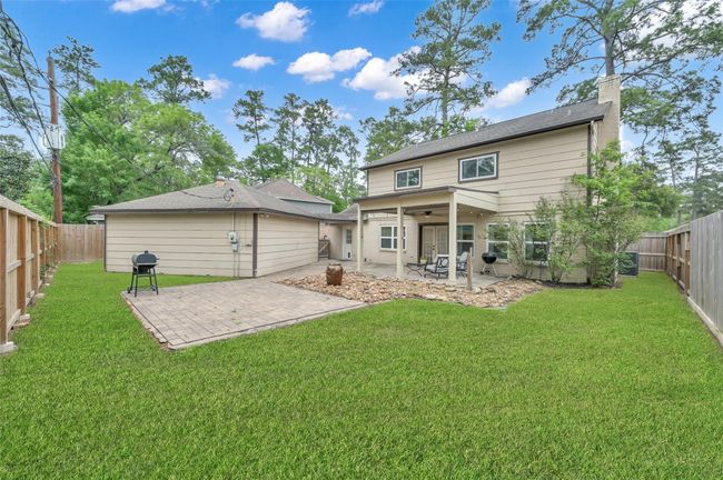 There is still plenty of lawn area for pets and playing without too much to mow. Fencing with rot board has been replaced over the last few years. The back of the home also has gutters. | Image 28