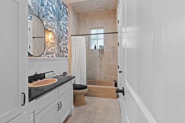Full bath with tile patterned floors, shower / bathtub combination with curtain, vanity | Image 24
