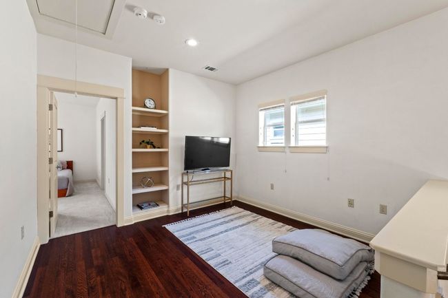 Upstairs has a bonus area for lounging, a reading nook, or an office. | Image 23