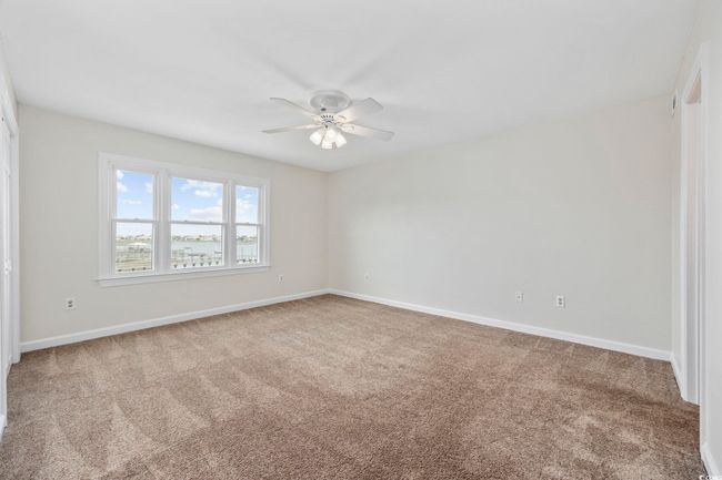 Unfurnished room featuring a ceiling fan, carpet floors, and baseboards | Image 30