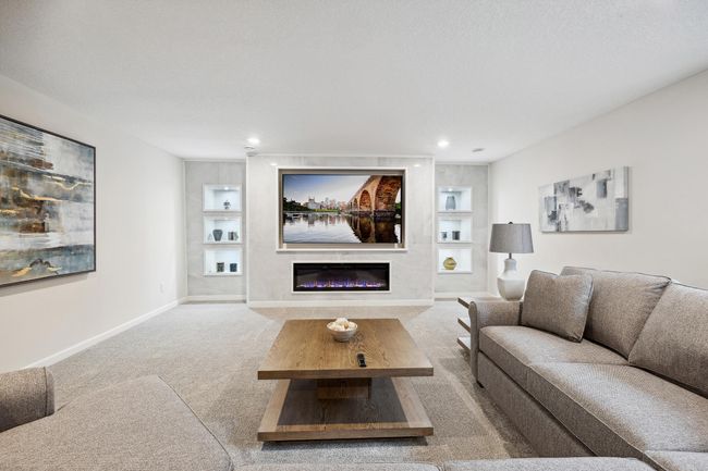 Lower level living room boasting a wonderful accent wall | Image 25