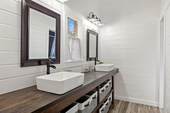 Full bathroom featuring double vanity and wood finished floors | Image 23