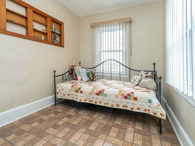 Bedroom featuring baseboards and brick floor | Image 8