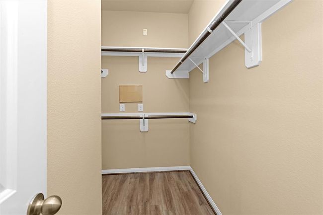 The primary bedroom’s walk-in closet offers ample space to accommodate a large wardrobe with ease. | Image 14
