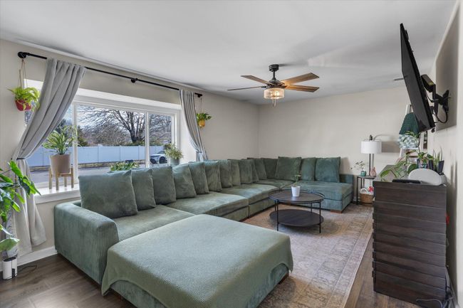 Living room featuring a ceiling fan and wood finished floors | Image 4