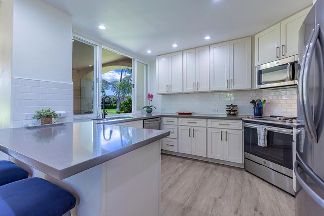The kitchen's large sliding windows double as a seamless pass-through to the spacious | Image 10