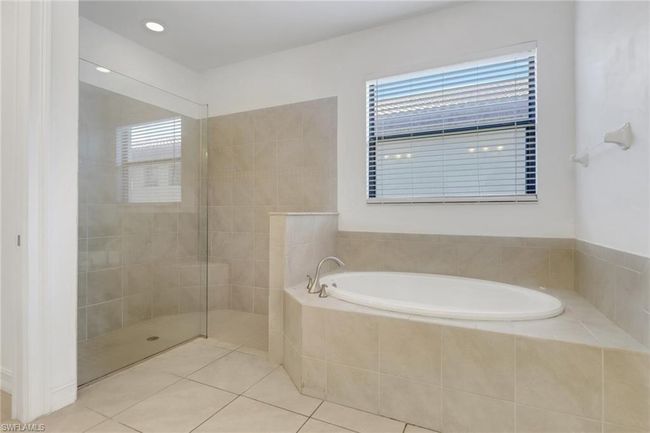 Full bathroom featuring a bath, tile patterned flooring, and walk in shower | Image 14