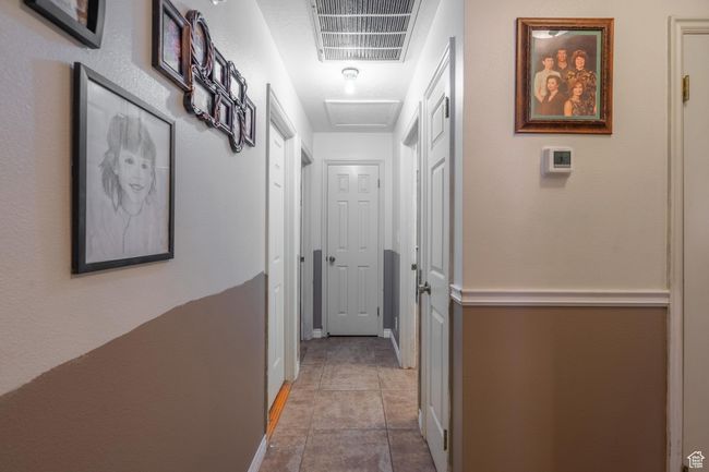 Corridor featuring tile patterned flooring and attic access | Image 38