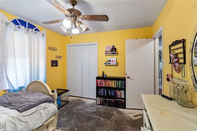 Bedroom with unfinished concrete floors, a closet, and ceiling fan | Image 26