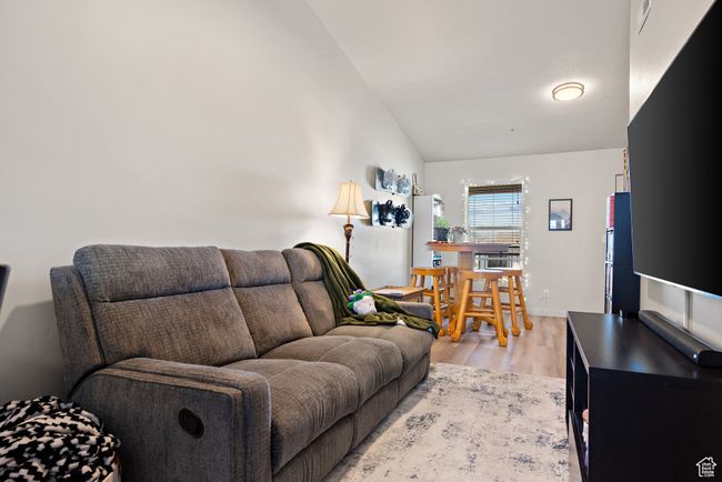 Living area with light wood-type flooring and lofted ceiling | Image 8