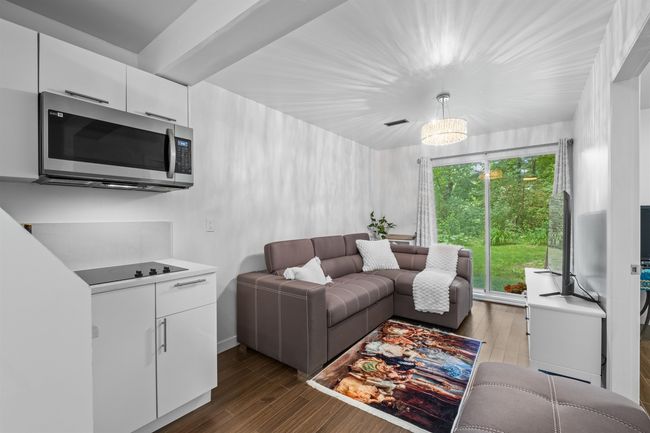 Living area featuring dark wood-style flooring | Image 13