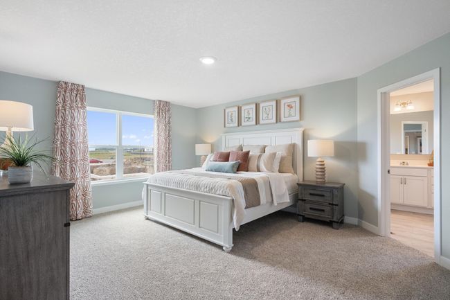 The primary suite is an oasis offering the perfect escape with private bath and two walk-in closets. Windows overlooking the backyard offering plenty of natural light. | Image 17