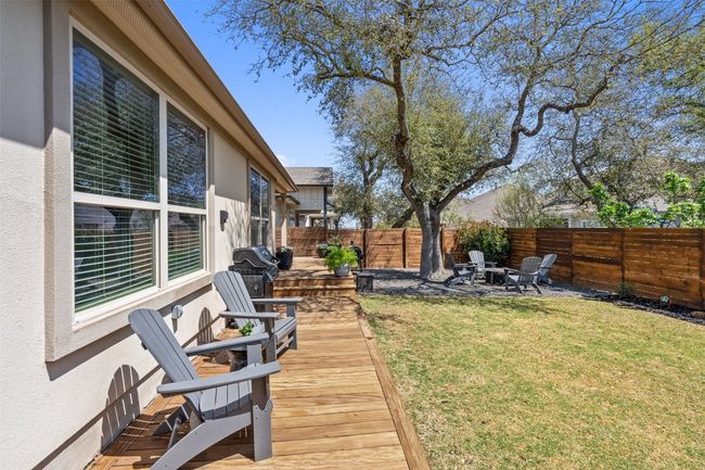Fenced backyard featuring a fire pit | Image 30