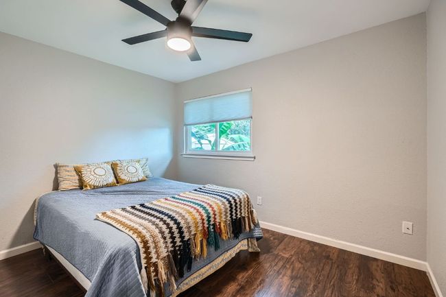 Bedroom featuring wood finished floors and ceiling fan | Image 19