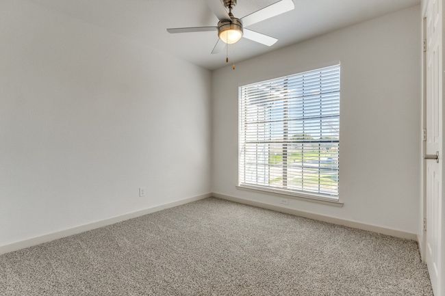 Empty room with ceiling fan and carpet | Image 33
