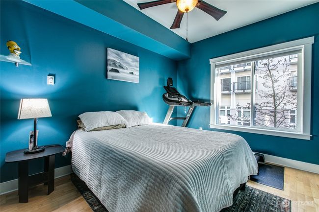 Bedroom w/ large window overlooking pedestrian boulevard | Image 9