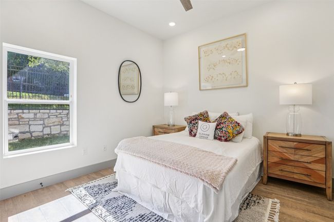 Bedroom featuring wood finished floors, ceiling fan, and recessed lighting | Image 12