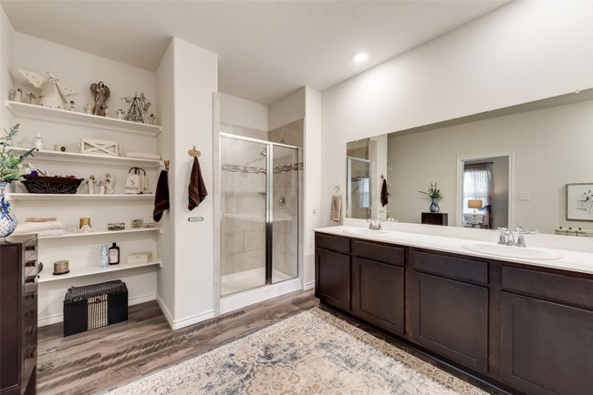 Full bathroom with wood finished floors, a stall shower, double vanity, and recessed lighting | Image 31