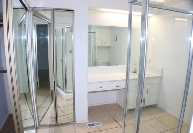Bathroom featuring vanity, tile patterned flooring, and a stall shower | Image 24