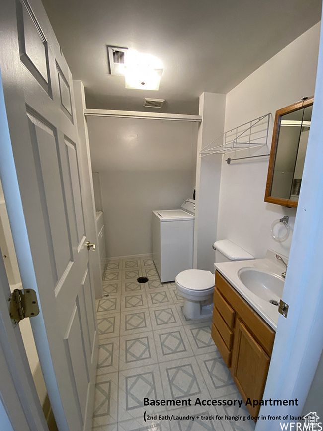 Full bathroom with toilet, washer / clothes dryer, a shower, and vanity | Image 48