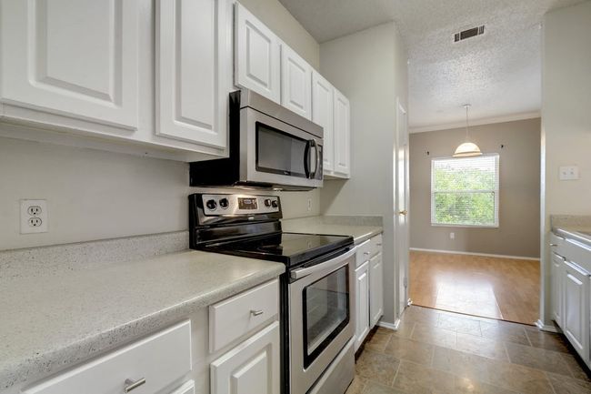 Kitchen with view into dining area. | Image 10