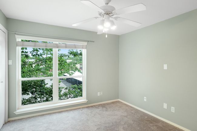 Unfurnished room featuring carpet flooring, baseboards, and ceiling fan | Image 15