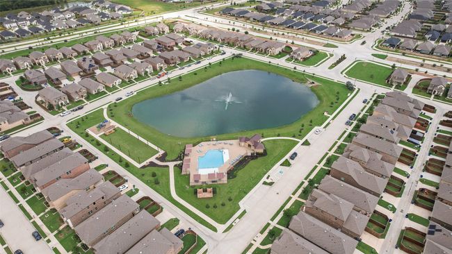 Aerial overview of property's location with nearby suburban area, a nearby body of water, and a pool area | Image 38