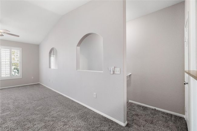 Spare room featuring carpet flooring, ceiling fan, lofted ceiling, and baseboards | Image 9
