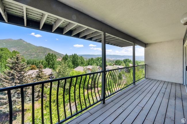 Wooden deck featuring a mountain view | Image 23