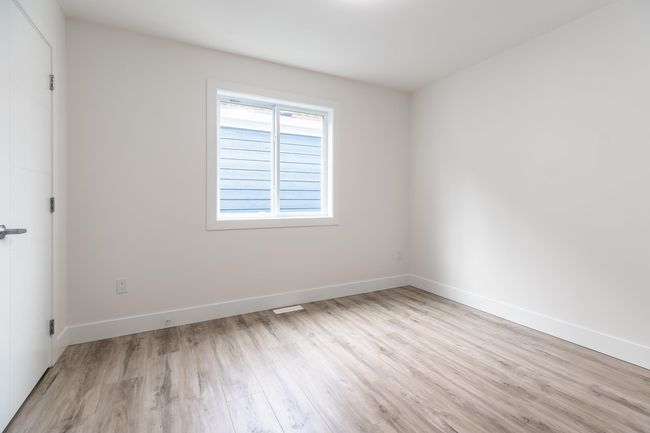 Spare room with wood finished floors and baseboards | Image 23