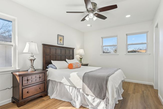 Bedroom with light wood-type flooring, baseboards, recessed lighting, and a ceiling fan | Image 19