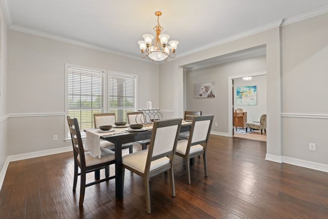 Formal dining, engineered hardwood floors and crown molding | Image 11