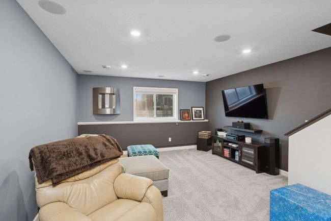 With large daylight windows that fill the area with natural light, the finished family room is an ideal spot for movie nights, gatherings, or a playroom. | Image 19