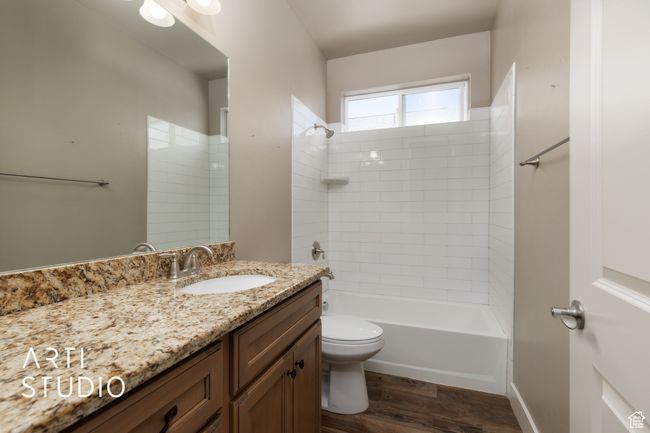 Full bath with vanity, wood finished floors, and shower / bath combination | Image 10