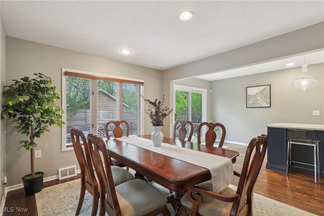 Dining space featuring dark wood-type flooring, recessed lighting, visible vents, and baseboards | Image 15
