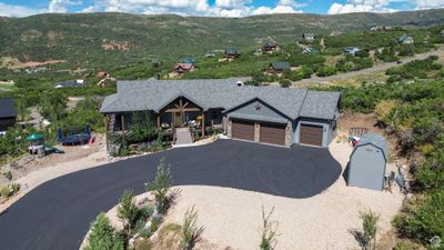 View of front of home with a mountain view and a garage | Image 2