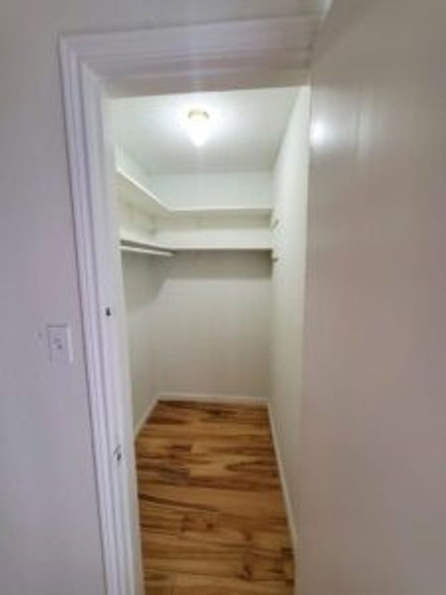 Walk in closet featuring wood finished floors | Image 22