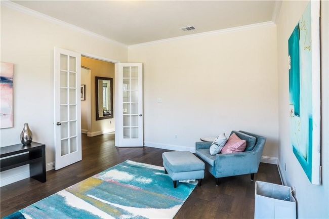 Living area with french doors, ornamental molding, and wood finished floors | Image 7