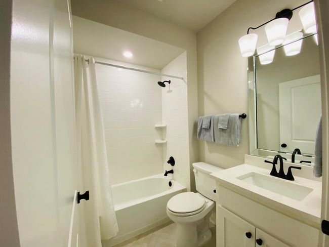 Guest bathroom with tub and shower. | Image 13