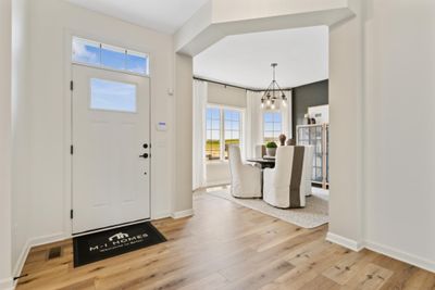 Foyer view of open den. Picture of model to show space with furniture. | Image 3