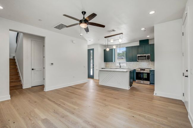 Kitchen with appliances with stainless steel finishes, light countertops, a ceiling fan, tasteful backsplash, and recessed lighting | Image 5