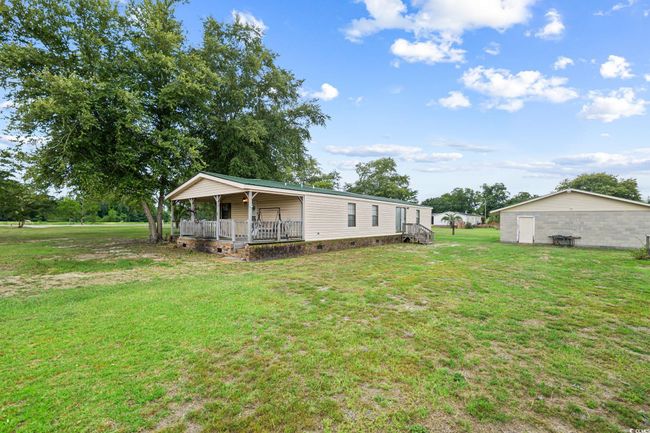 Back of property featuring covered porch and a lawn | Image 27