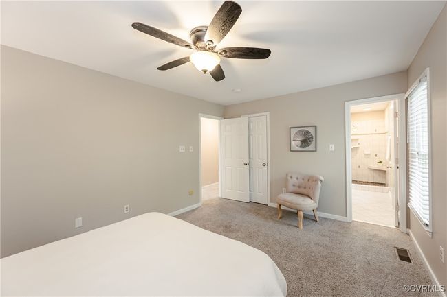 Primary featuring light colored carpet, baseboards, and visible vents | Image 32
